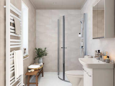 Bilde av det lille baderommet i vinkelhuset Josefine med baderomsinnredning og grå våtromspaneler